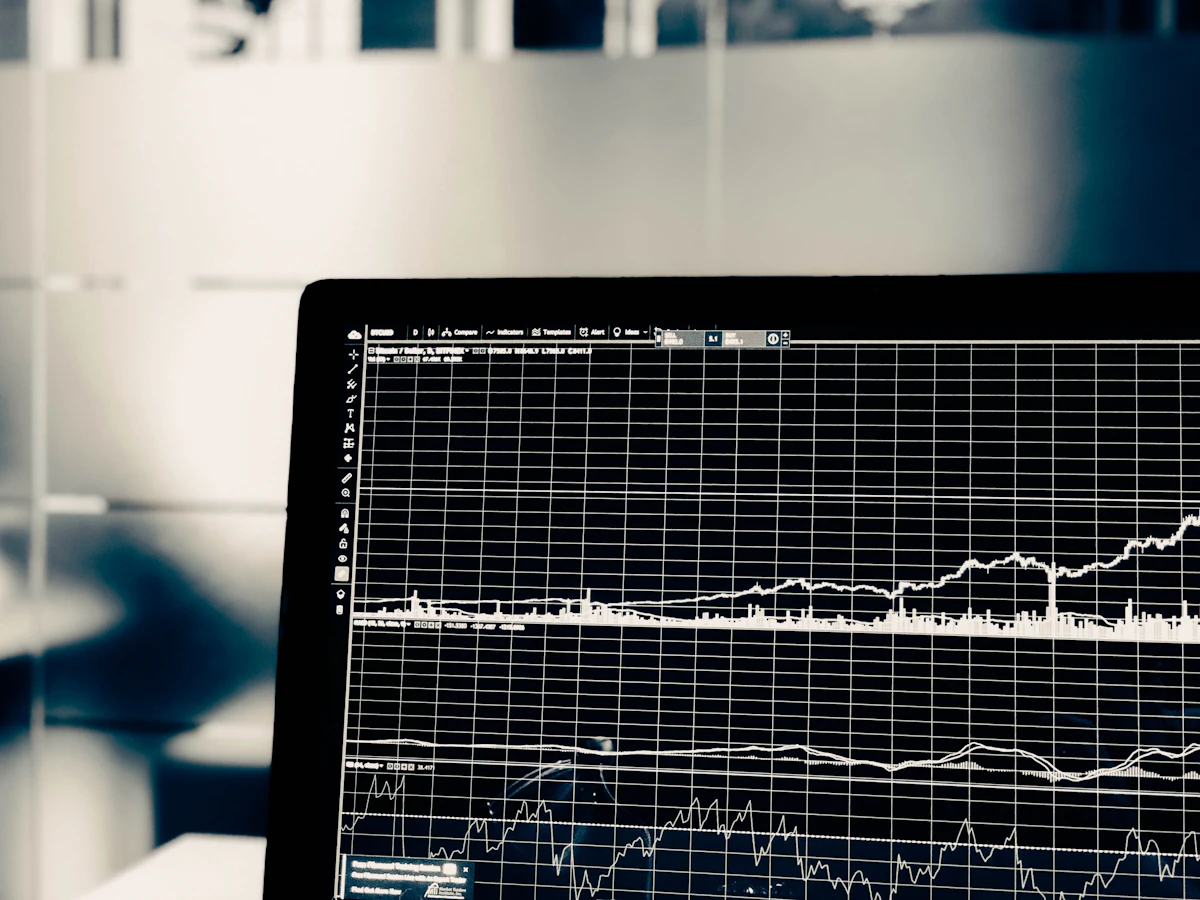 Trader with head in hands looking at losses on screen